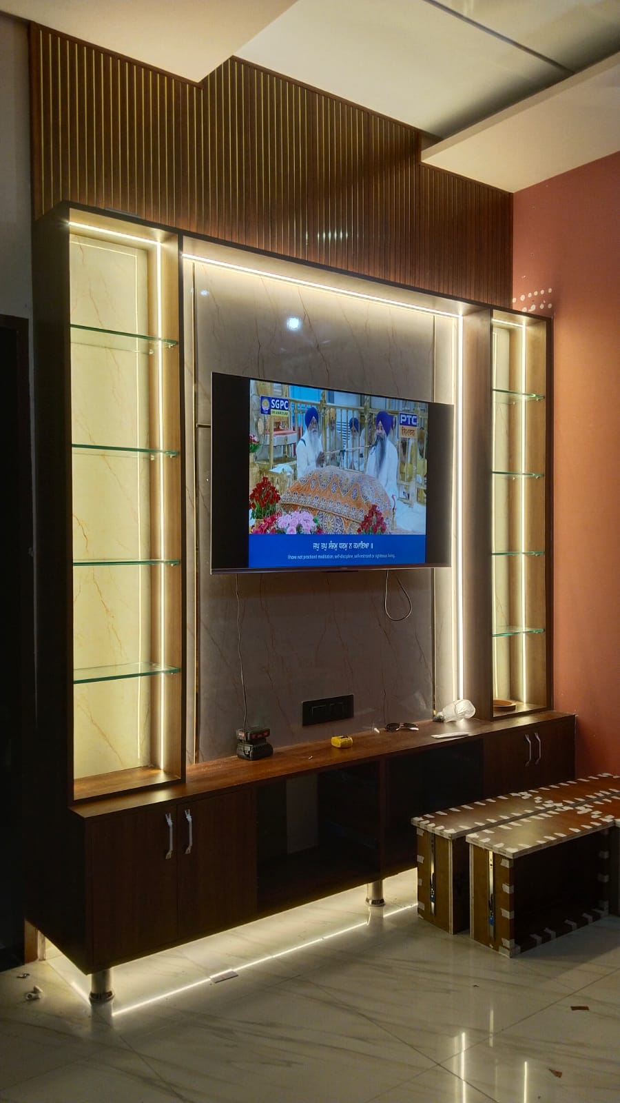 TV wall unit in use with the television playing and accent lighting on